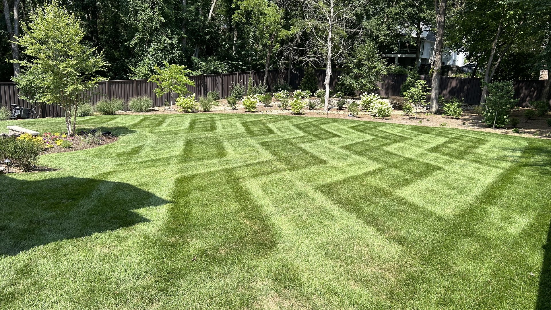 Zig-zag mowing stripes on a green lawn